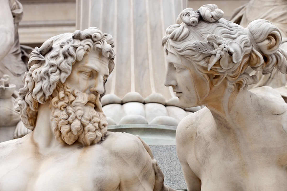 Image of an ancient greek statue of a man and a woman looking at each other