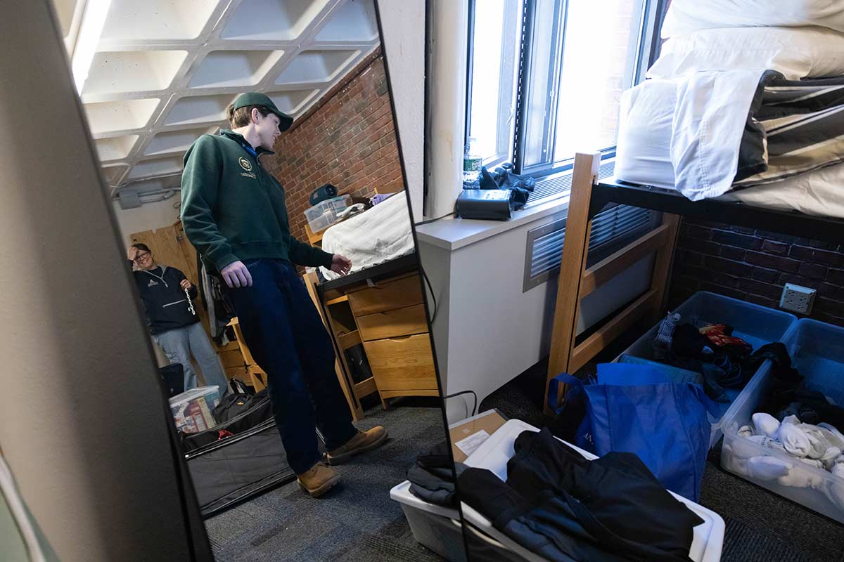 A student unpacks inside a residence hall