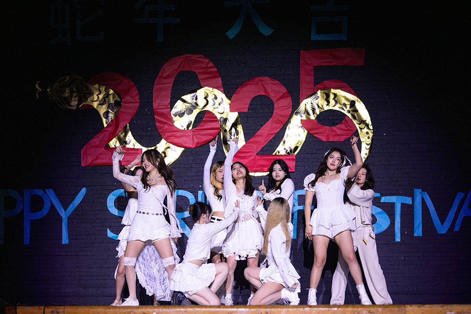 A group of dancers performs on stage.